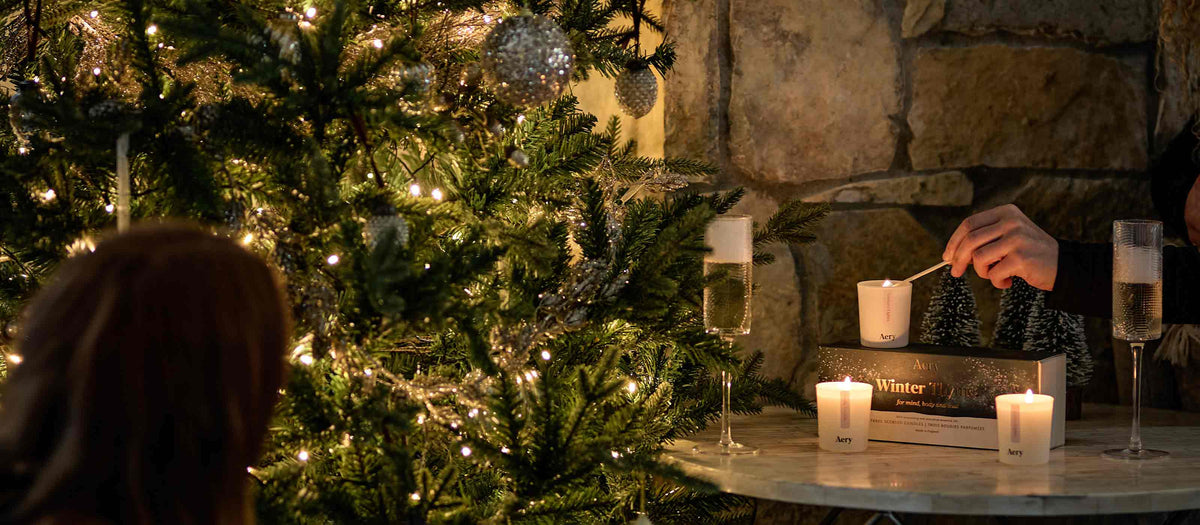 social setting with drinks and candles next to christmas tree