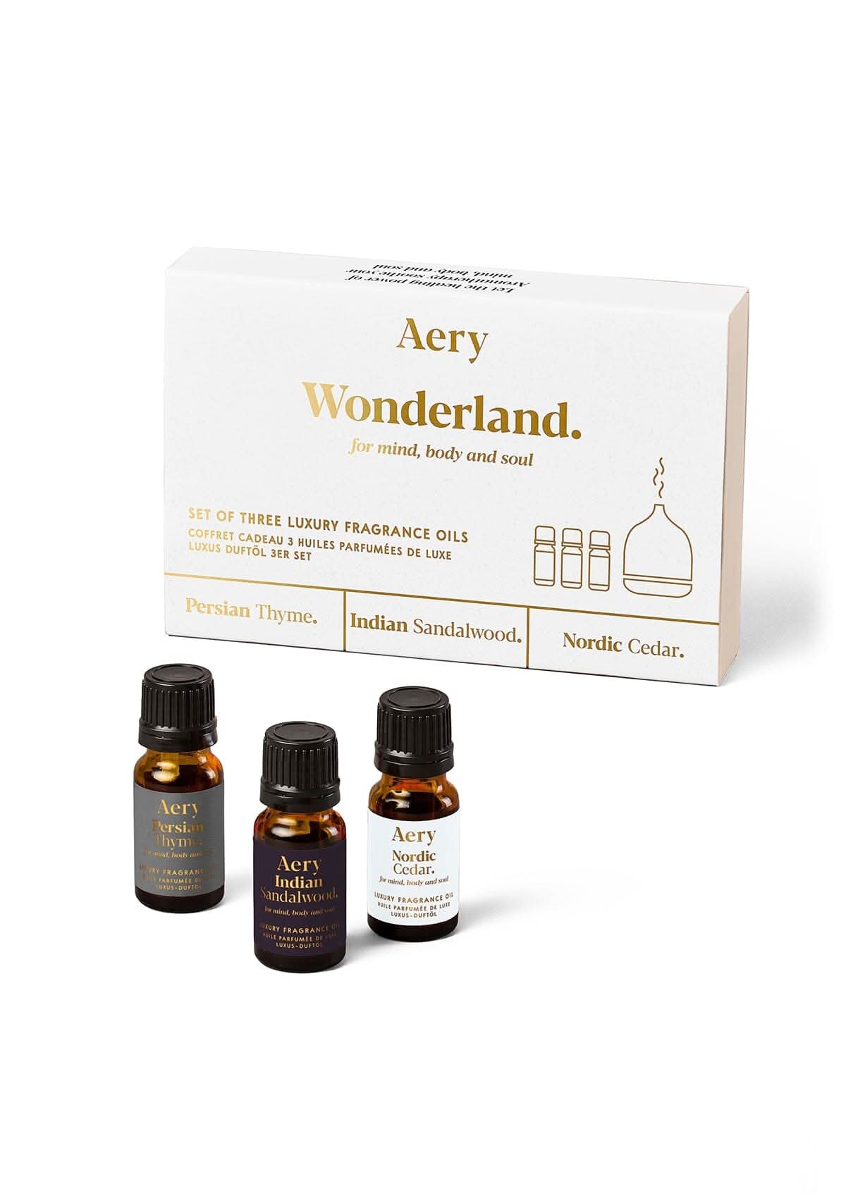 White Wonderland fragrance oil set of three displayed next to product packaging by Aery on white background
